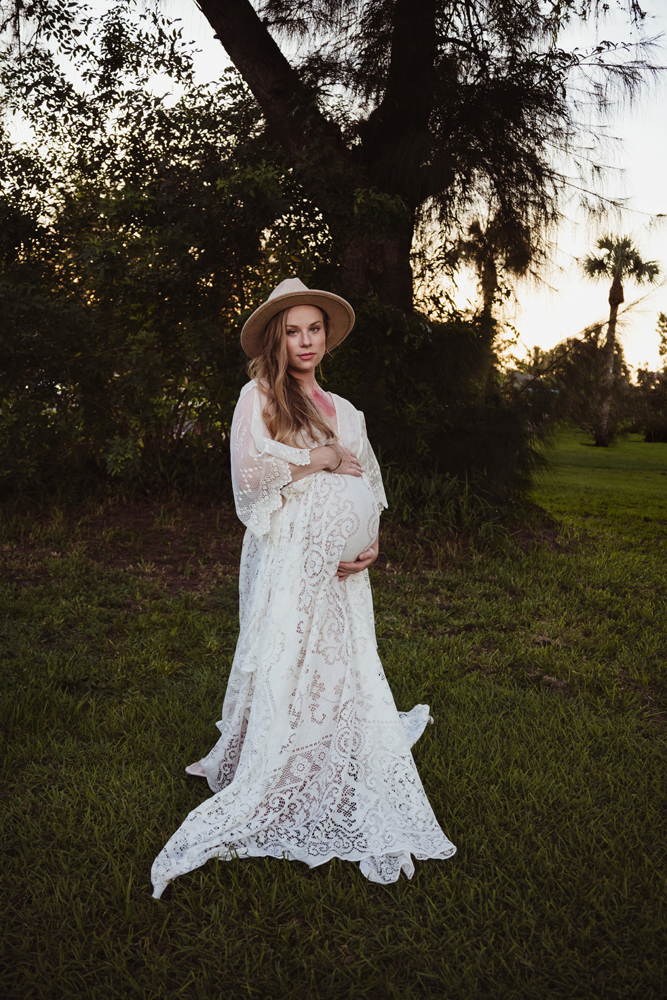 vintage lace maternity dress rental on a blonde with a red birthmark on her neck and a boho fedora hat