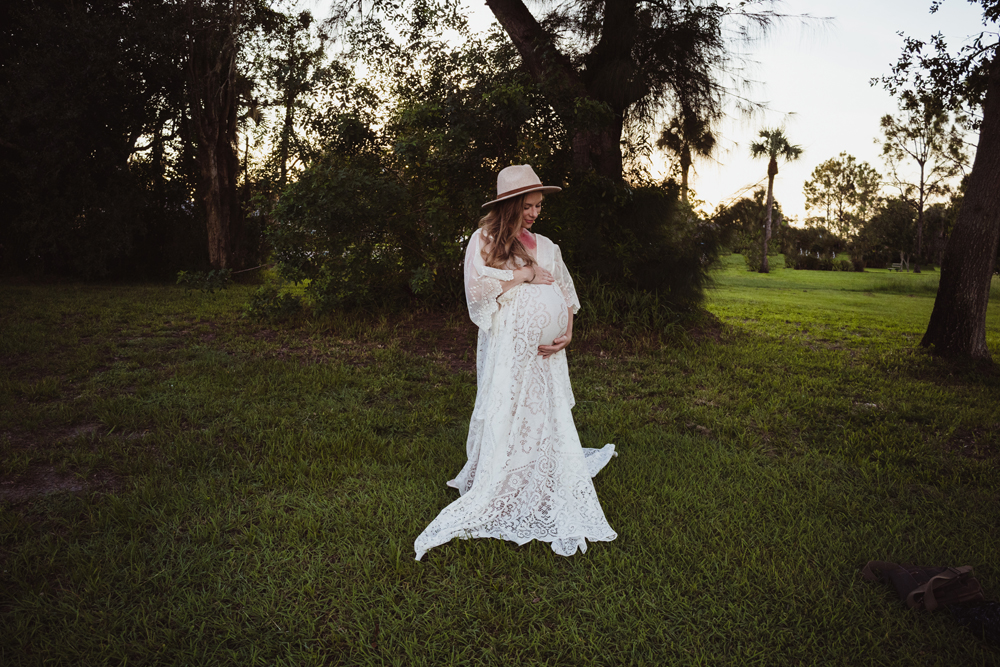 vintage lace maternity dress rental on a blonde with a red birthmark on her neck and a boho fedora hat