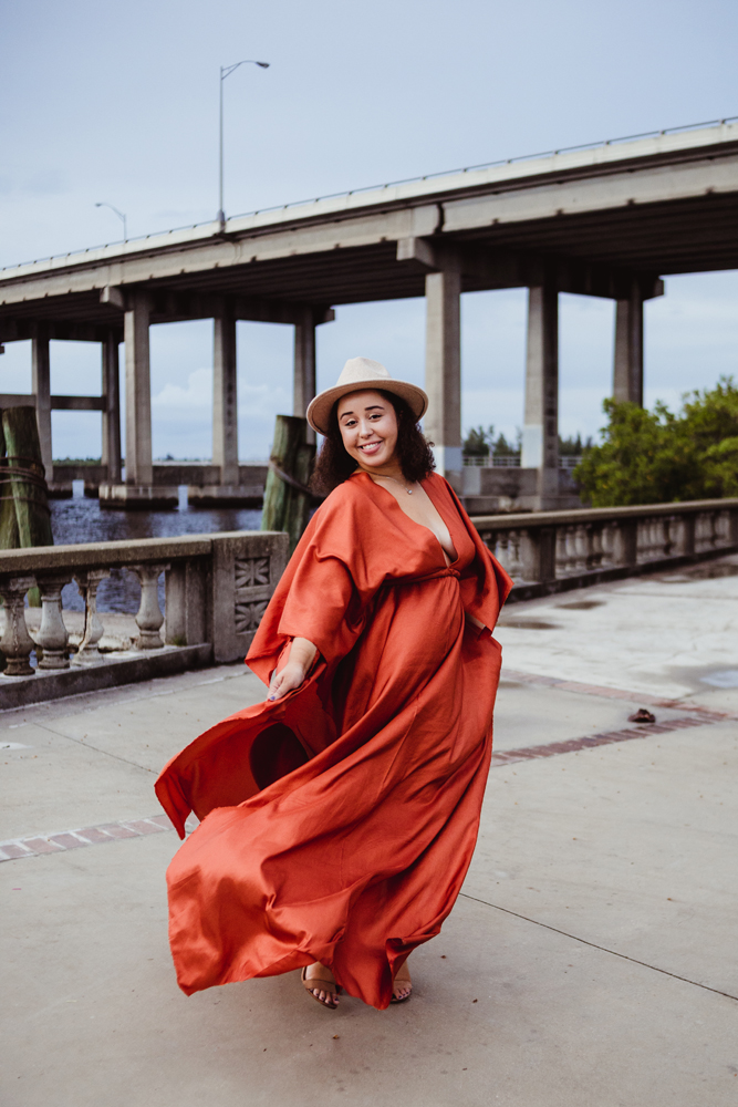 rust poppy colored silk photography dress on a woman of color